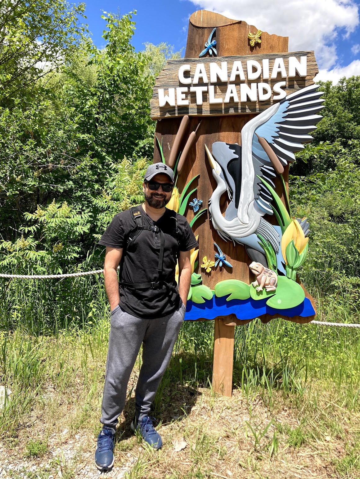 Varun at Canadian Wetlands sign during a nature outing